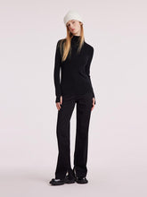 A lady wears a wool sheath sweater.